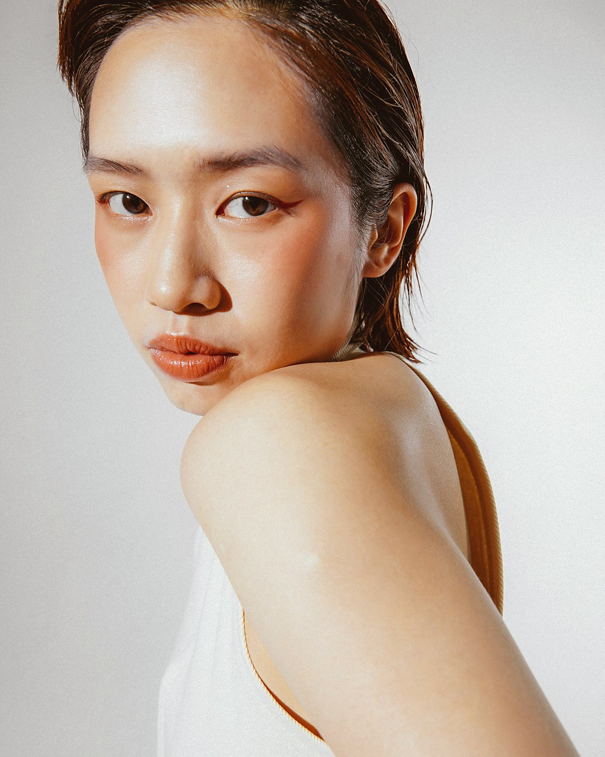 A portrait turned away from the light, shoulder bare