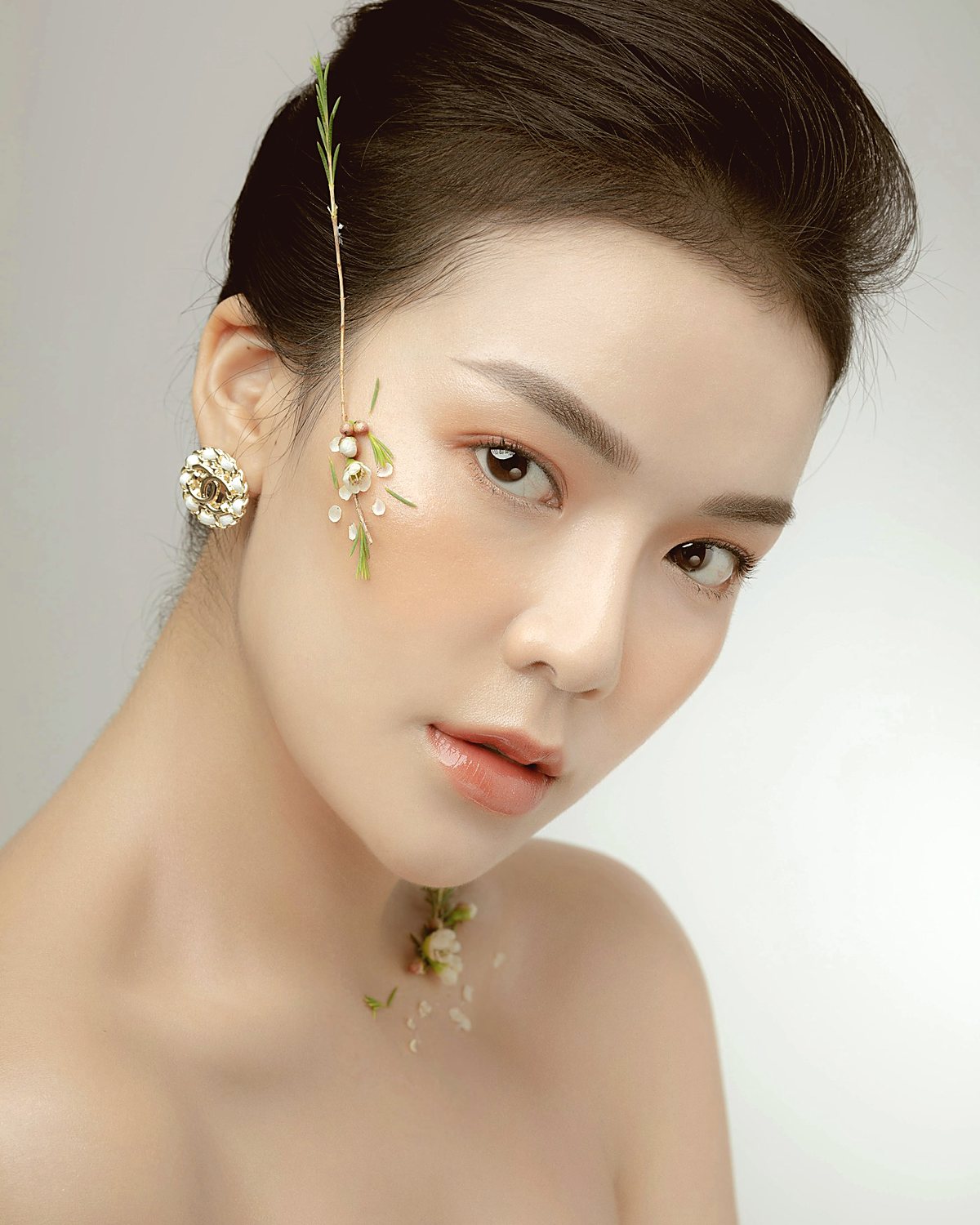 A woman photographed in soft daylight against a pale background