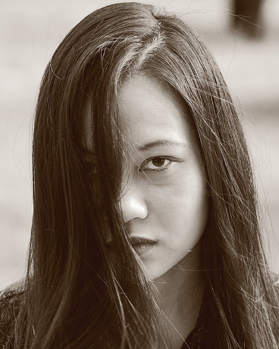 A portrait in black and white, hair loose